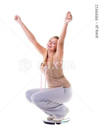Woman plus size on scale celebrating weightloss 9899912