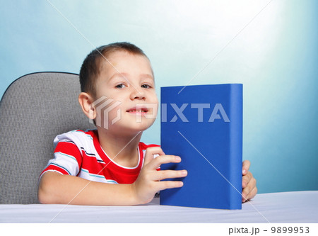 child boy kid reading a book on blue child boy kid reading a book on blue 9899953