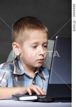 Computer addiction child with laptop notebook 9899986