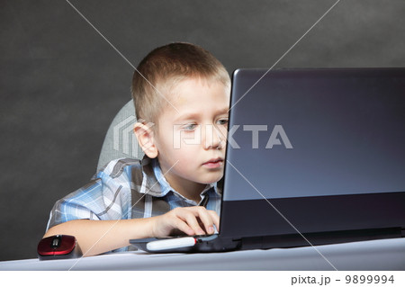 Computer addiction child with laptop notebook Computer addiction child with laptop notebook 9899994