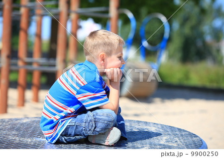 thoughtful child boy or kid on playground thoughtful child boy or kid on playground 9900250