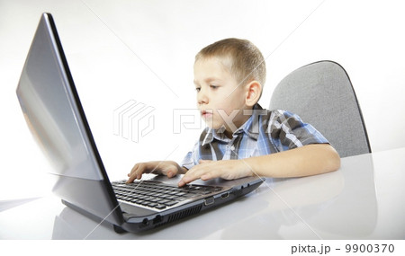 Computer addiction child with laptop notebook 9900370