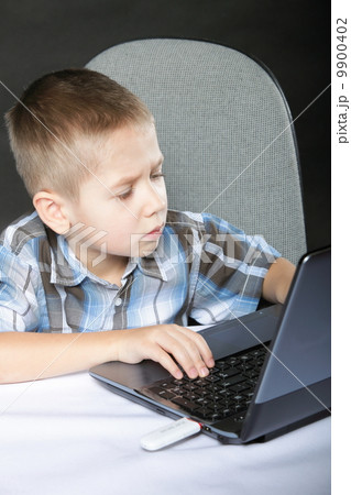 Computer addiction child with laptop notebook Computer addiction child with laptop notebook 9900402