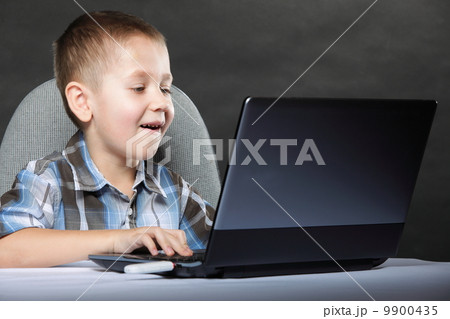 Computer addiction child with laptop notebook 9900435