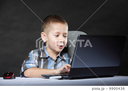Computer addiction child with laptop notebook 9900436