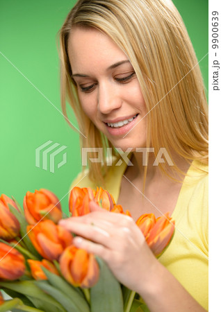 Woman looking down spring flowers orange tulips Woman looking down spring flowers orange tulips 9900639