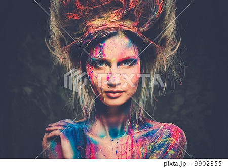 Young woman muse with creative body art and hairdo 9902355