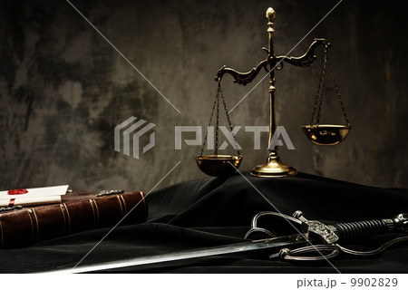 Scales, book and Sword of Justice on a judge's mantle Scales, book and Sword of Justice on a judge's mantle 9902829