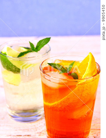 Orange, elderflower cocktails on blue background Orange, elderflower cocktails on blue background 9905450