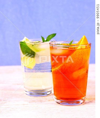 Orange, elderflower cocktails on blue background 9905451