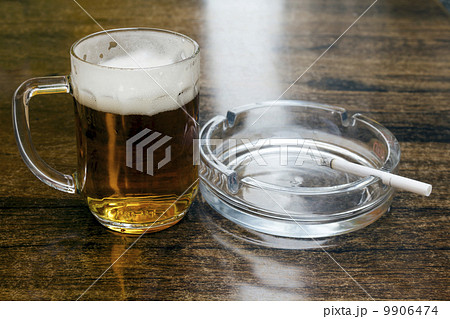 glass of beer and an ashtray 9906474