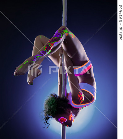 Pretty girl posing hanging upside down on pylon 9914663
