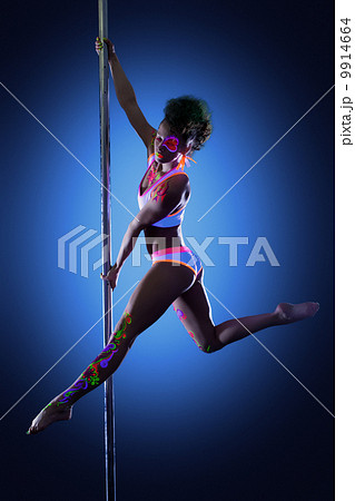 Sexy pole dancer posing with ultraviolet makeup 9914664