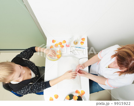 Beautician cleaning cuticles hands female client. Beauty salon. Beautician cleaning cuticles hands female client. Beauty salon. 9915922