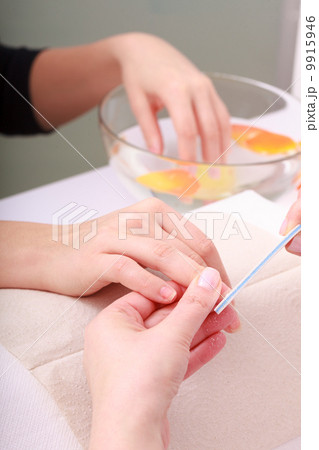 Beautician with file filing nails female client. Woman spa beauty salon Beautician with file filing nails female client. Woman spa beauty salon 9915946