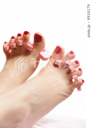 foot pedicure applying red toenails on white 9916279