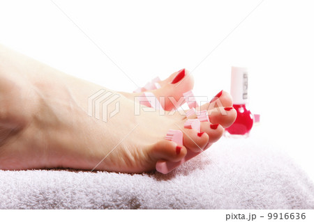 foot pedicure applying red toenails on white 9916636