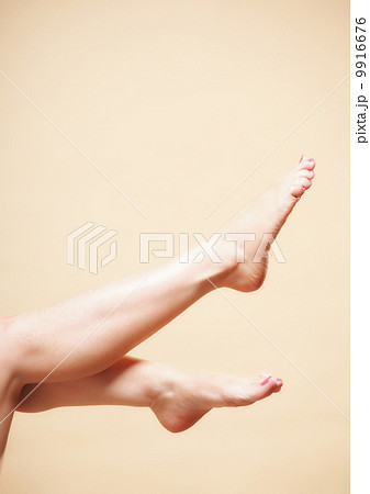 Beautiful long naked woman girl legs on orange 9916676