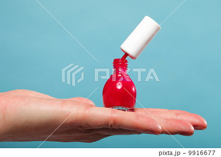pedicure manicure red nail polish on female palm pedicure manicure red nail polish on female palm 9916677
