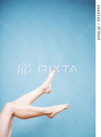 Beautiful long naked woman girl legs on blue Beautiful long naked woman girl legs on blue 9916944
