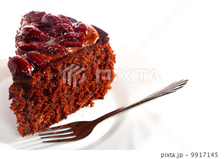 Piece of chocolate cake with icing and cherry Piece of chocolate cake with icing and cherry 9917145