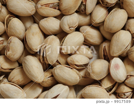 Closeup of pistachios in nut shells as food background Closeup of pistachios in nut shells as food background 9917589