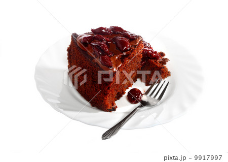 Piece of chocolate cake with icing and cherry Piece of chocolate cake with icing and cherry 9917997