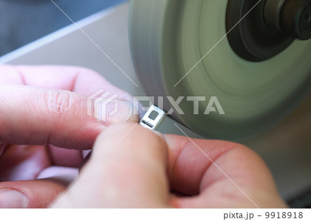 hands of jeweller at work. Silver polishing. 9918918