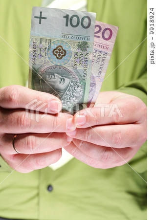 Businessman holding money 100 polish zloty Businessman holding money 100 polish zloty 9918924