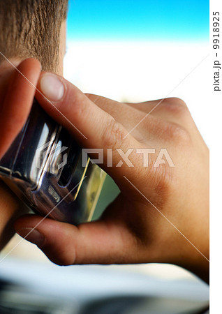 A man, talking on one cellular phone A man, talking on one cellular phone 9918925
