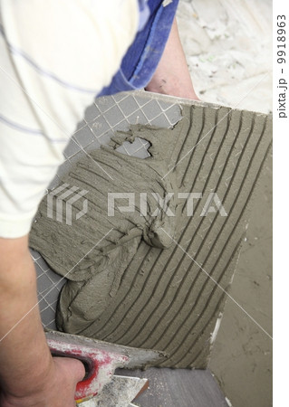 tiler at work bonding of floor tile adhesive tiler at work bonding of floor tile adhesive 9918963