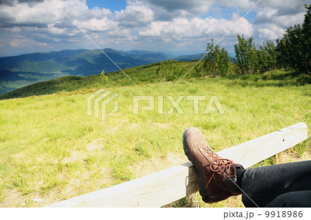Hiking shoes. Hiker enjoying view relaxing 9918986
