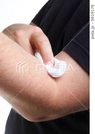 appying a swab to an arm after blood sample 9919176