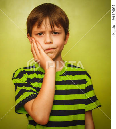 young kid boy child toothache pain in mouth, dental pain, holdin 9919861