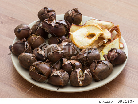 Tasty roasted chestnuts and dried sliced apples Tasty roasted chestnuts and dried sliced apples 9921207