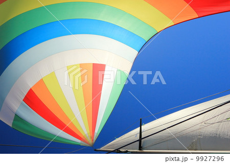The wind has filled colorful spinnaker sail 9927296