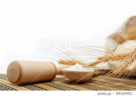 Flour and wheat grain with wooden spoon on a wooden table. Flour and wheat grain with wooden spoon on a wooden table. 9930992