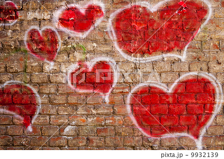 red hearts painted on a brick wall 9932139