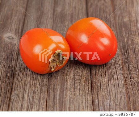 Fresh ripe persimmon on wooden table. 9935787