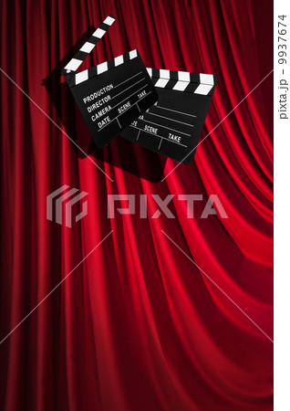 Movie clapper board against curtain 9937674