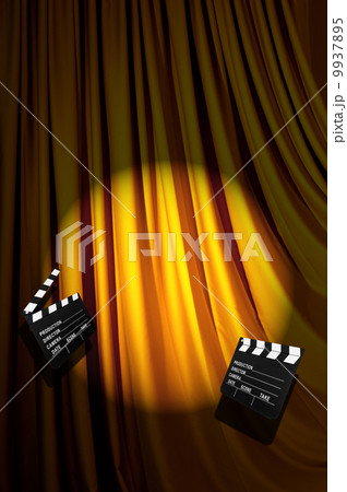 Movie clapper board against curtain 9937895