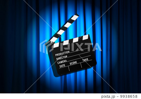 Movie clapper board against curtain 9938658