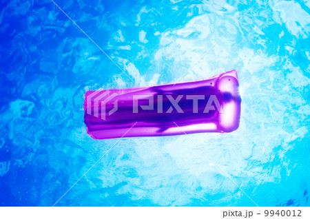 Woman relaxing on inflatable mattress, view from underwater Woman relaxing on inflatable mattress, view from underwater 9940012