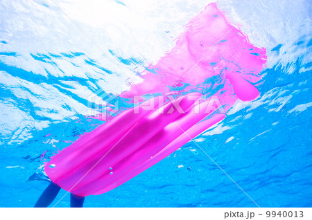 Woman relaxing on inflatable mattress, view from underwater Woman relaxing on inflatable mattress, view from underwater 9940013