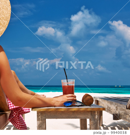 Woman at beach with chaise-lounges Woman at beach with chaise-lounges 9940038