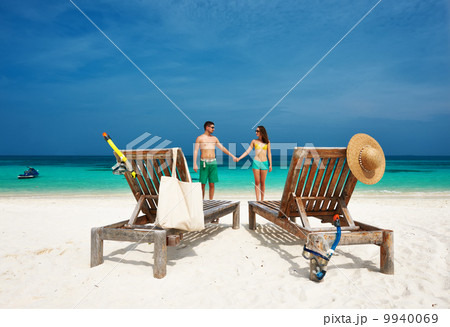 Couple in green on a beach at Maldives 9940069