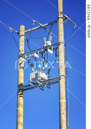 High voltage power transformer on a blue sky background 9942188