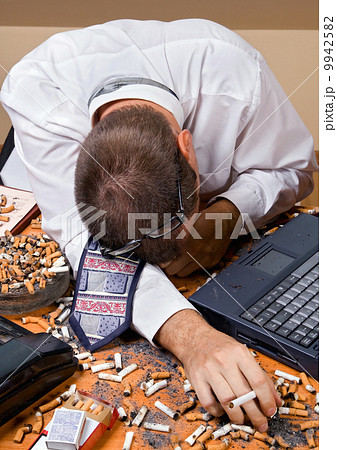Tired businessman sleep on table Tired businessman sleep on table 9942582