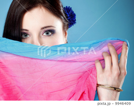 woman hides her face with shawl 9946409