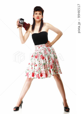 Pretty retro girl with vintage camera 9946517